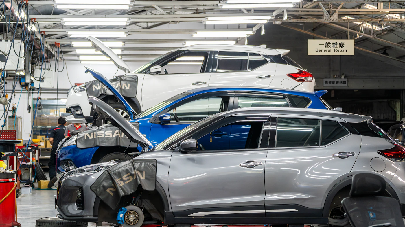 Cars being serviced in an automotive workshop.