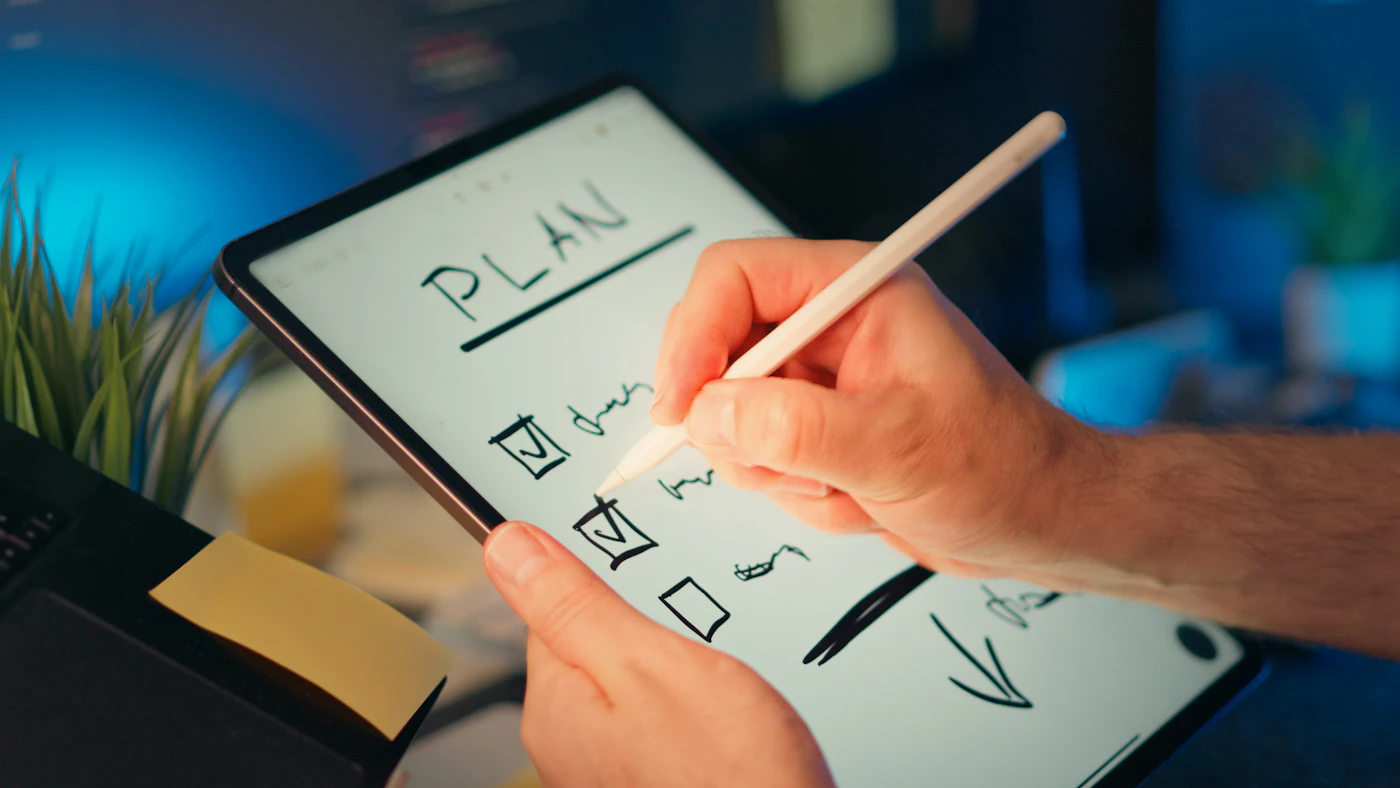 A person planning a project on a tablet.