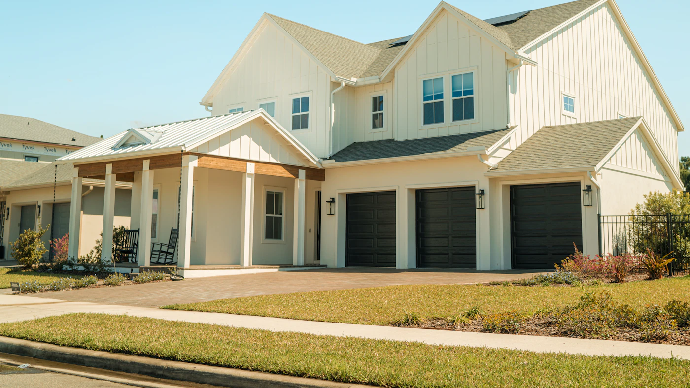 Exterior of a residential property with two garage doors.