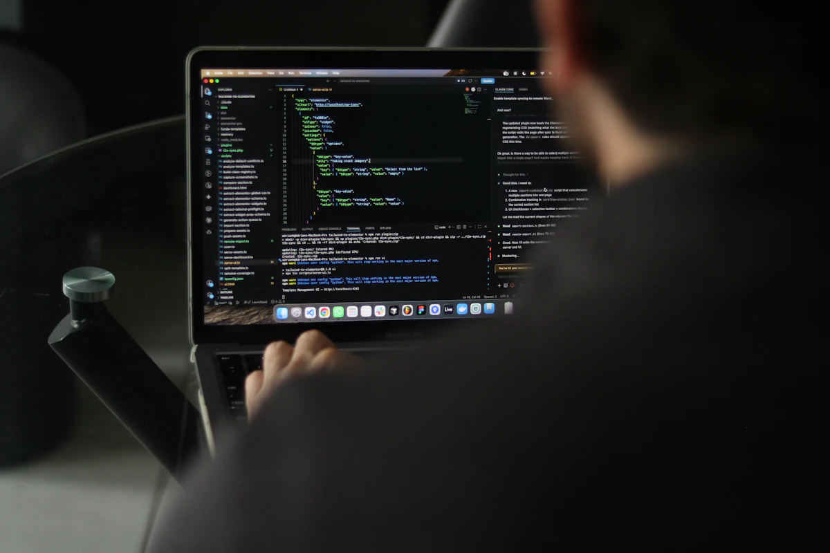 Developer working on website code on a laptop